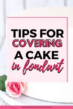 a white cake with pink flowers on top and the words tips for covering a cake in fondant