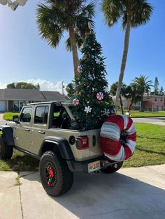 a jeep with a christmas tree in the back