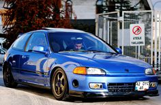 a blue car parked in front of a building