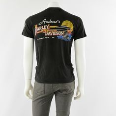 "Black double-sided graphic tee shirt. Front with Masters of Thunder # 1 series &2 motorcycle racers. Back of tee has Andrea's Harley Davidson Urbana, IL. 1992copyright date. Great pre-owned vintage, however, there is a hole in the left underarm about 1/2\" long. Vintage Tag Size: M 38-40 Material: cotton Closure: Pullover Chest: 38\" Length: 28\" -------------------------------------------------------------------------------- Gender: Men Modified Item: No Country/Region of Manufacture: Unit Vintage Crew Neck Top With Front And Back Print, Vintage Short Sleeve Tops For Motorcycling, Vintage Short Sleeve T-shirt For Motorcycling, Retro Graphic Print T-shirt For Biker Events, Vintage Short Sleeve Motorcycling T-shirt, Vintage Crew Neck T-shirt For Motorcycling, Mom Jeans Shorts, High Rise Mom Jeans, Floral Print Skirt