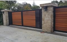 an iron and wood fence with two gates