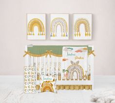 a baby crib with three pictures on the wall next to it and a teddy bear