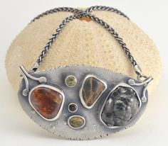 "This sterling silver pendant necklace features a selection of stones: a botryoidal hematite, a fire agate, a black and orange beach stone, an orange brown agate, and faceted lemon quartz and smoky quartz. This grouping of stones has been set in a pendant, which I hand fabricated in recycled sterling silver with an organic rough edge. The necklace has been oxidized and selectively brushed to highlight the details, and is stamped with my maker's mark. The centerpiece of the necklace measures abou Silver Tourmaline Necklaces With Natural Stones, Silver Tourmaline Necklace With Natural Stones, Unique Silver Tourmaline Necklace, Multiple Earrings, Brown Agate, Silver Jewelry Design, Fire Agate, Orange Beach, Lemon Quartz