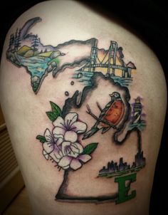 a woman's thigh with flowers and birds in the shape of a world map