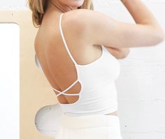 Low back cropped cami with criss-cross detail. COLORS: Melon; Yellow; White Made in USAFabric: 92% Nylon / 8% Spandex One size fits most. Fitted Crisscross Top With Built-in Bra, Fitted Crisscross Crop Top With Built-in Bra, Fitted Tank Top With Built-in Bra And Cross Back, Chic Crop Top With Built-in Bra And Strappy Back, Trendy Fitted Sports Bra For Spring, Summer High Stretch Cross-back Sports Bra, High Stretch Cross Back Sports Bra For Summer, Stretch Sports Bra With Multiple Straps And Cross Back, Summer Strappy Back Stretch Crop Top