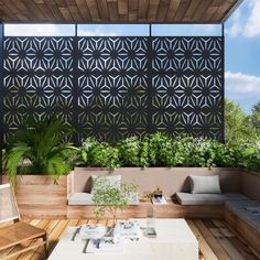 an outdoor living area with wooden furniture and plants