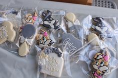 several decorated cookies in plastic bags on a table