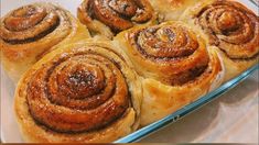 several cinnamon rolls in a glass baking dish