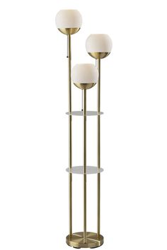 three light floor lamp with glass shelves and two lamps on each side, one is gold