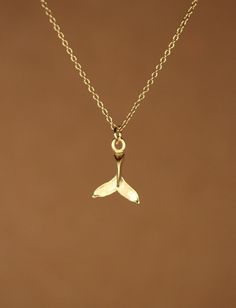 Gold whale tail necklace, beach necklace, tropical jewelry, whale tail necklace, a 14k gold vermeil whale tail on a 14k gold filled chain This easy to wear 14k gold vermeil whale tail hangs from a 14k gold filled chain in the length of your choice! This necklace is also available in sterling silver :) This little charm measures 12mm x 10mm. Please use the last photo in this listing as a reference for measurement. The WhaleTail... This symbol stands for speed and strength. It also refers to the s Gold Whale, Whale Tail Necklace, Tropical Jewelry, Beach Necklace, Beach Necklaces, Poutine, Whale Tail, Girly Jewelry, Dream Jewelry