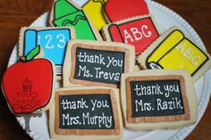 decorated cookies on a plate with chalkboard saying thank you teacher