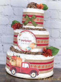 a three tiered cake decorated with pumpkins and burlocks on the side