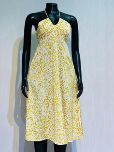 a mannequin wearing a yellow and white dress with leopard print on it's chest