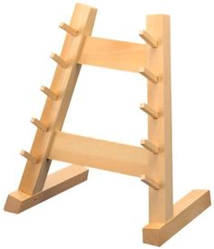 a wooden rack with several pegs on it's sides and the top section missing