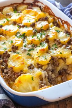 a casserole dish with potatoes, meat and cheese