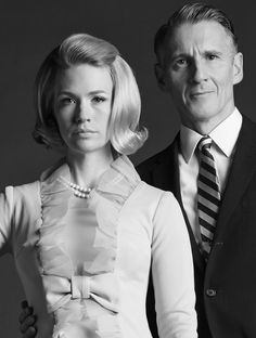 a man and woman posing for a black and white photo