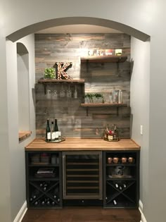 a wine cellar with shelves and bottles on the wall