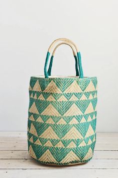 Our eye-catching jute bags have a contemporary geometric triangle design. Handmade and fairtrade. With roped handles and a plain cotton inside lining with zip pocket. Use it as a shoulder bag or home storage basket!  The perfect companion for shopping, travelling and everyday use. Handcrafted from jute, this spacious tote is durable and sustainable.  ❃ Dimensions: Height 35cm. Width 48cm. Diameter at base 25cm ❃ Materials: Sustainable Jute.  ❃ Made on a Fairtrade basis in Bangladesh using only locally grown natural materials such as jute and hogla (local sea-grass). Please note: all our bags are handmade using natural materials and so measurements/colour may vary slightly from that shown, but will be just as beautiful. ❃ A PURCHASE WITH PURPOSE ❃ By purchasing a Kantha Karma item you are c Green Woven Jute Bag, Green Jute Straw Bag For Daily Use, Handmade Green Jute Beach Bag, Green Jute Tote Shoulder Bag, Green Jute Crochet Bag For Daily Use, Green Jute Straw Tote Bag, Green Jute Tote Straw Bag, Green Handwoven Jute Shoulder Bag, Eco-friendly Green Jute Shoulder Bag