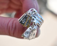 "Silver ring with charms decorated with pagan symbols. The ring has two names Bride's Ring or Seven Day Ring. It is replica of ancient Latvian ring. Charms are decorated with Latvian protective signs (Baltic pagan runes) from Lielvarde belt. According to historic evidence, it was believed that when a young girl or unmarried woman wears this ring and charms start falling off, then it's time to get married. The 7 charms with ancient Latvian symbols keep away evil spirits and bring luck... Symbol m Latvian Ring, Pagan Runes, Baltic Symbols, Latvian Symbols, Luck Symbol, Pagan Symbols, Unmarried Women, Charm Rings, Evil Spirits