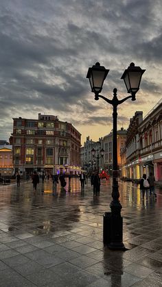 people are walking around in the city at dusk