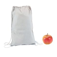 an apple sitting next to a drawsack bag