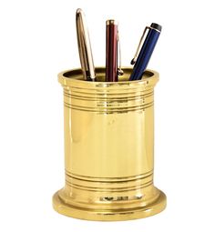 three pens in a gold cup on a white background