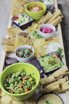 a long table filled with different types of food and dips on top of it