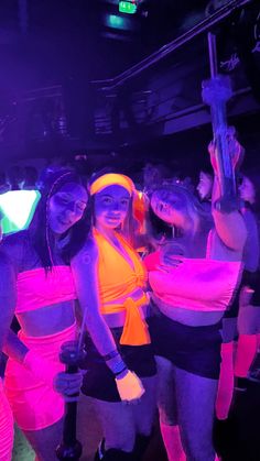 several women in neon outfits posing for the camera