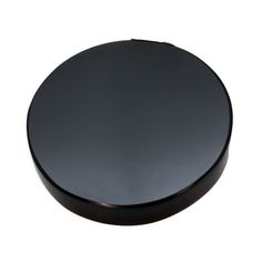 a black round object sitting on top of a white surface