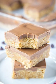 three pieces of peanut butter bars stacked on top of each other with chocolate in the middle