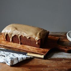 a loaf of cake sitting on top of a wooden cutting board