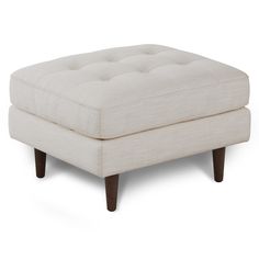 a white ottoman sitting on top of a wooden frame