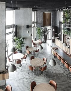 an empty restaurant with wooden tables and chairs