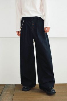 The Crinkled Button-Fly Wide-Leg Pants effortlessly blend simplicity with comfort. Featuring a crinkled texture cascading from the waistband down the front, these pants add a touch of depth and dimension to your look. The front fly is adorned with wooden buttons, adding a natural, rustic charm. With a wide-leg silhouette, these oversized pants offer both style and ease, crafted from premium fabric for a relaxed yet refined appearance. Crinkled texture from waistband down Wooden button fly Wide-l Casual Black Wide Leg Pants With Buttons, Baggy Wide-leg Pants With Buttons, Oversized Pants, Sneakers And Socks, Jean Accessories, Wooden Buttons, Premium Fabric, Rustic Charm, Short Pants