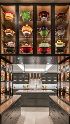 a kitchen filled with lots of glass cupboards covered in dishes and pans next to each other