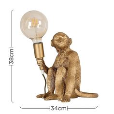 the monkey lamp has a light bulb attached to it's back and sits on its hind legs