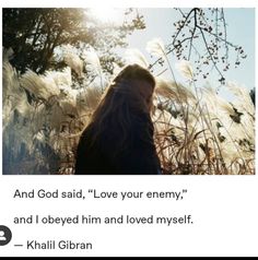 a woman standing in tall grass with the words, and god said, love your enemy