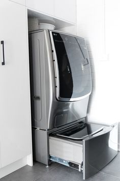 a kitchen with white cabinets and stainless steel appliances