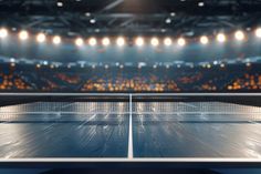 a ping pong table in front of an empty arena with lights on it and people watching from the stands