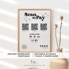 the scan to pay poster is displayed next to a vase with flowers and a plant