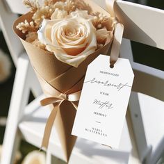 a bouquet of flowers sitting on top of a white chair with a price tag attached to it