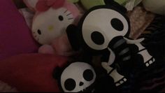 hello kitty stuffed animals are lined up on a bed