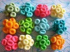 there are many different colors of beads on the table, and one is made out of fondant