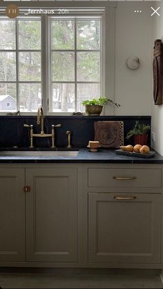 an image of a kitchen setting with sink and window