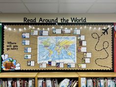 a bulletin board with pictures and words on it in front of a book shelf filled with books