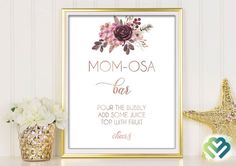 a gold framed sign with flowers on it next to a potted plant and starfish