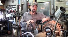 a man working in a shop with lots of tools