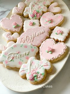 decorated cookies are arranged on a white plate