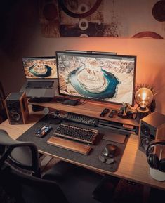 two computer monitors sitting on top of a wooden desk next to a keyboard and mouse