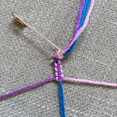 a close up of a piece of cloth with some knitting needles and yarn on it